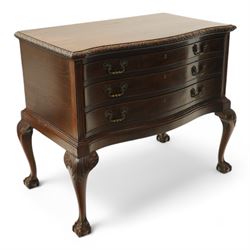 20th century oak and mahogany serpentine chest, the moulded top carved with trailing crossed ribbon and flower heads, fitted with three long cock-beaded drawers, ornate cast gilt metal handles, on acanthus leaf carved cabriole supports with ball and claw feet 