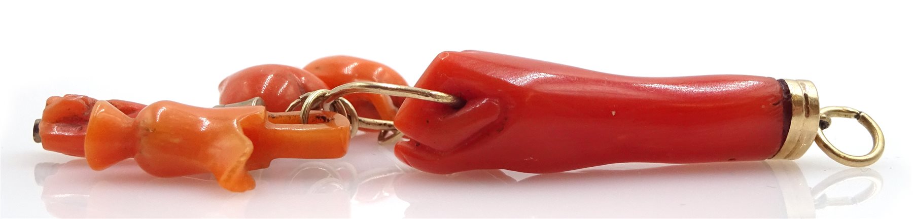 Victorian gold carved coral hand charm holding a heart, hand, jug, sword and mouse