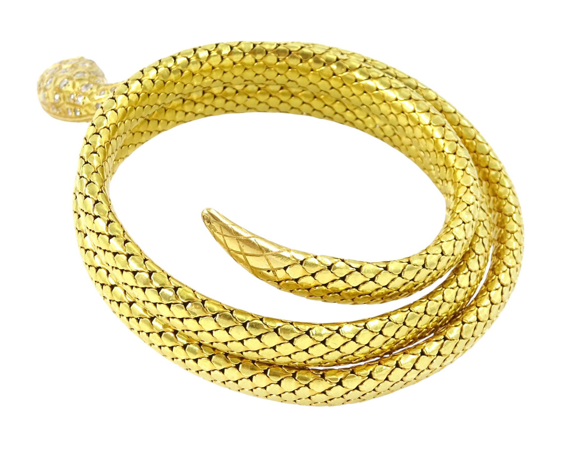 18ct gold coiled diamond snake bangle, the head set with round cut diamonds and emerald eyes, to an expanding articulated body, stamped Brevete S.G.D.G.