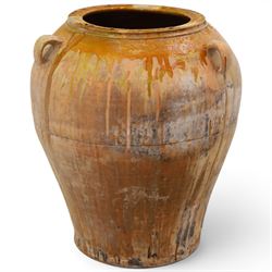 Large Spanish terracotta olive jar, of typical baluster form with drip glaze decoration an...