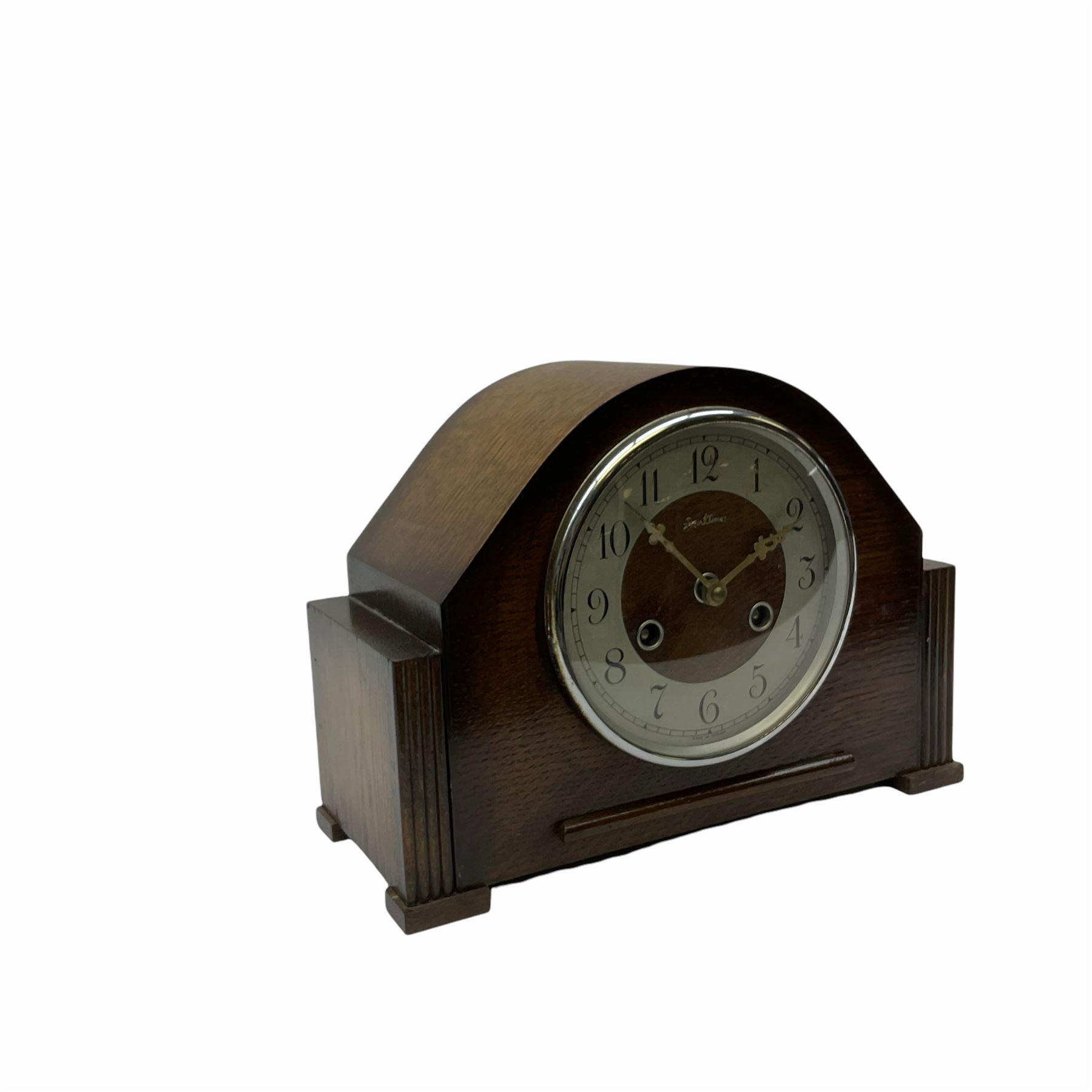 Oak cased mid-20th century “Bentima” English eight-day spring driven mantle clock with a striking movement striking the hours and half hours on a coiled gong, movement stamped for the Perivale Clock Manufacturing Company Ltd, London, with a silver finished chapter ring, upright Arabic numerals and minute track , baton hands and chrome bezel with glass.