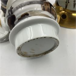 Two 19th century continental teapots and warmers, each teapot upon a cylindrical warming base in the form of a castle, hand printed with winter landscapes, largest H22cm 