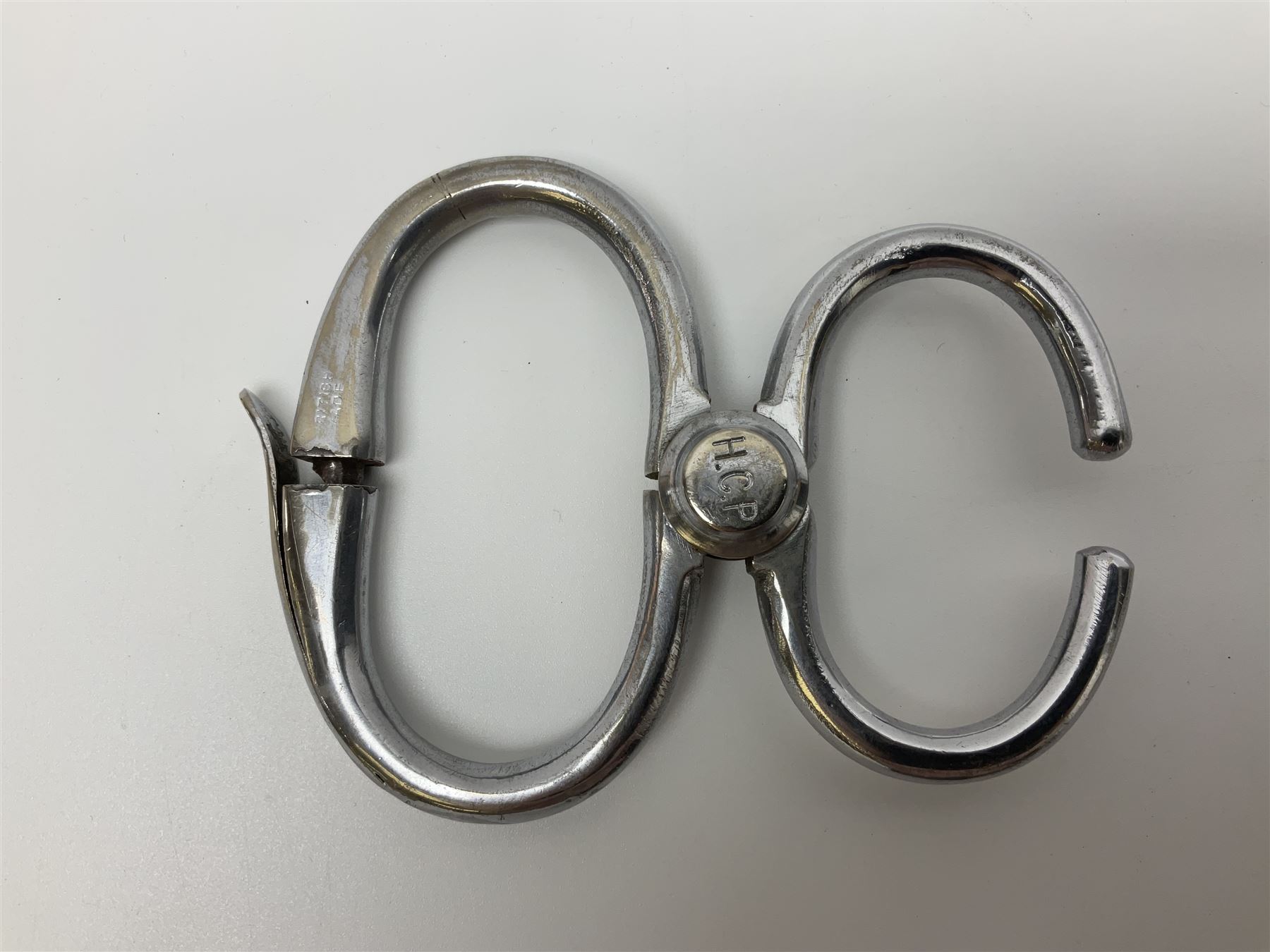 Police - two pairs of steel nipper handcuffs, one stamped Hull City Police; two other chromium plated Hiatt steel nipper handcuffs, each stamped HCP (?Hull City Police); and a pair of chromed steel articulated handcuffs stamped WRC (?West Riding Constabulary) (5)