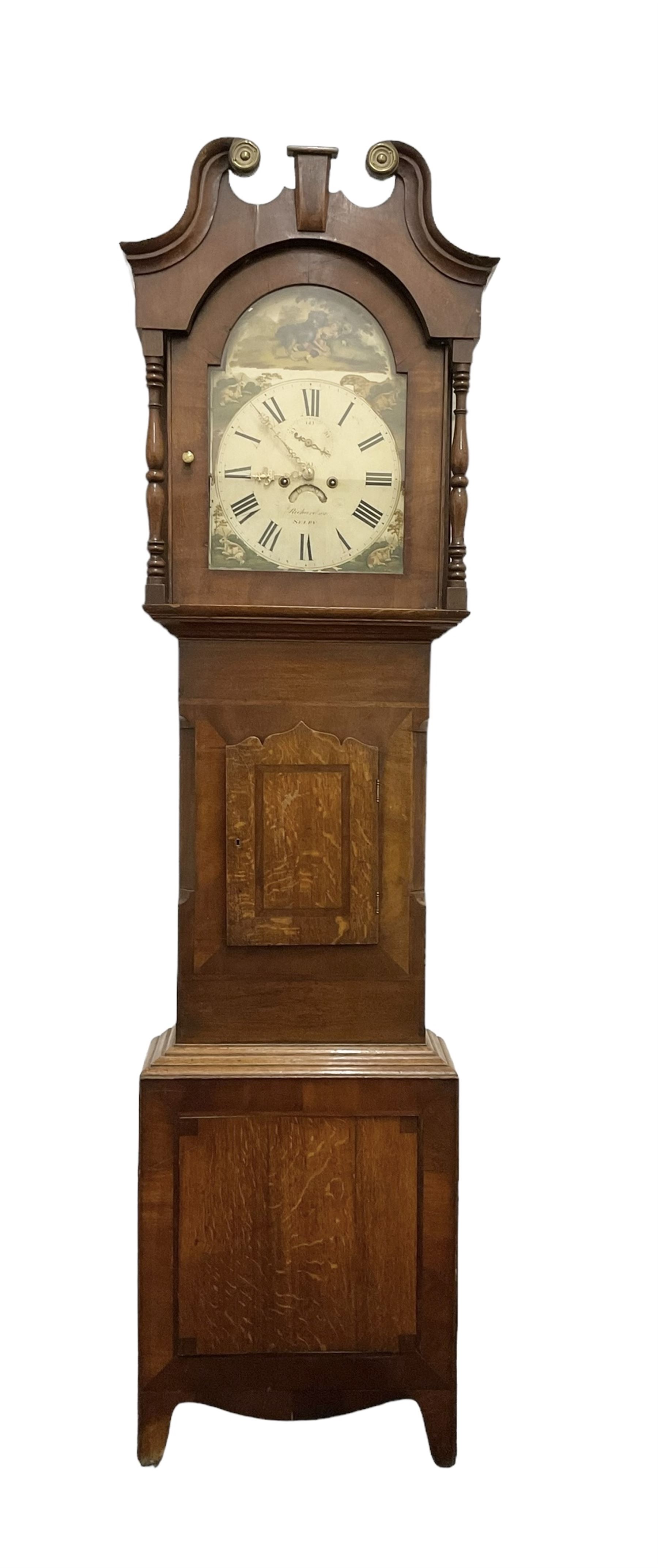 Richardson of Selby - late 19th century oak and mahogany longcase clock c 1860, with a swan necked pediment and brass paterie, break arch hood door flanked by ring turned pilasters,  oak trunk with crossbanding and a small inlaid trunk door, tall plinth with panel inlay with a shaped base,
painted dial with depictions of matching farm animals to the spandrels and a dog and small child to the arch, with Roman numerals, minute track, stamped brass hands, calendar aperture and seconds dial, weight driven rack striking movement, striking the hours on a bell. With weights and pendulum.