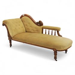 Victorian walnut chaise longue, carved with scrolling acanthus to the end supports and seat rail, upholstered in mustard coloured velvet, shaped and buttoned back and side with turned spindle gallery, raised on short turned legs with ceramic castors 