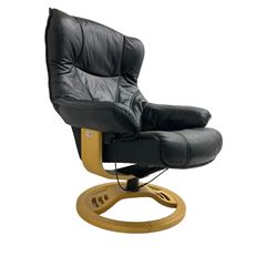 Anderssons of Sweden - mid-20th century design swivel armchair, upholstered black leather, raised on beech U-frame supports with circular base, together with matching footstool 