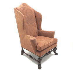 Georgian style mahogany framed high wing back armchair, upholstered in a patterned terracotta studded fabric, turned supports joined by stretchers, W97cm