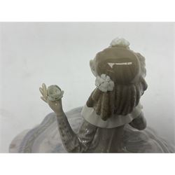 Lladro figure, Teresa, modelled as a lady in a crinoline dress with a basket of flowers, sculpted by José Puche, with original box, no 5411, year issued 1987, year retired 1989, H15cm