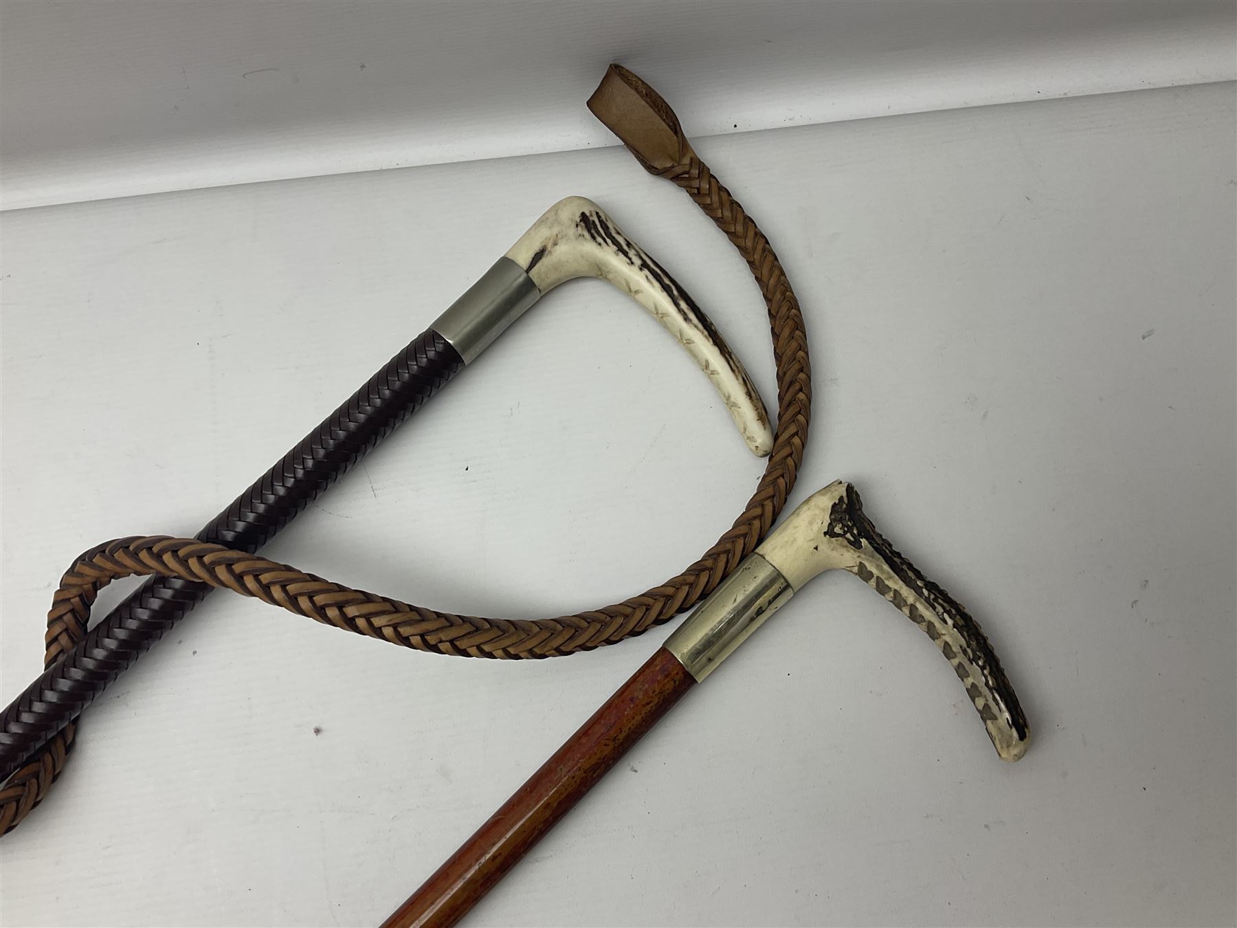 Collection of hunting crops and riding whips, including horn handle examples with silver cuffs
