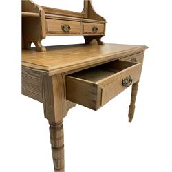 Late 19th century pitch pine dressing table, raised swing mirror back with two small trinket drawers, the table fitted with two drawers, on turned supports