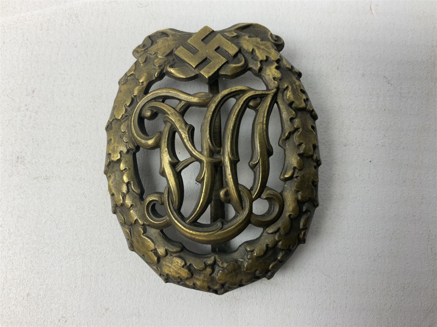 Two WW2 German Sports badges - SA sports badge marked verso 'W.Redo Eigentum D. Obersten SA. Fuhrung Saar Lautern'; and DRL sports badge marked verso 'Wernstein Jena D.R.G.M. 35269' (2)