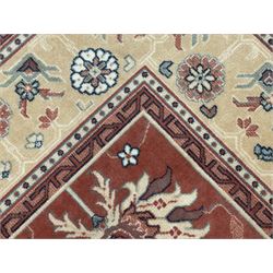 Late 20th century Royal Keshan 'Agra' hand-knotted wool rug, terracotta ground with central floral medallion and scrolling vines, enclosed by a cream border with repeating floral motifs