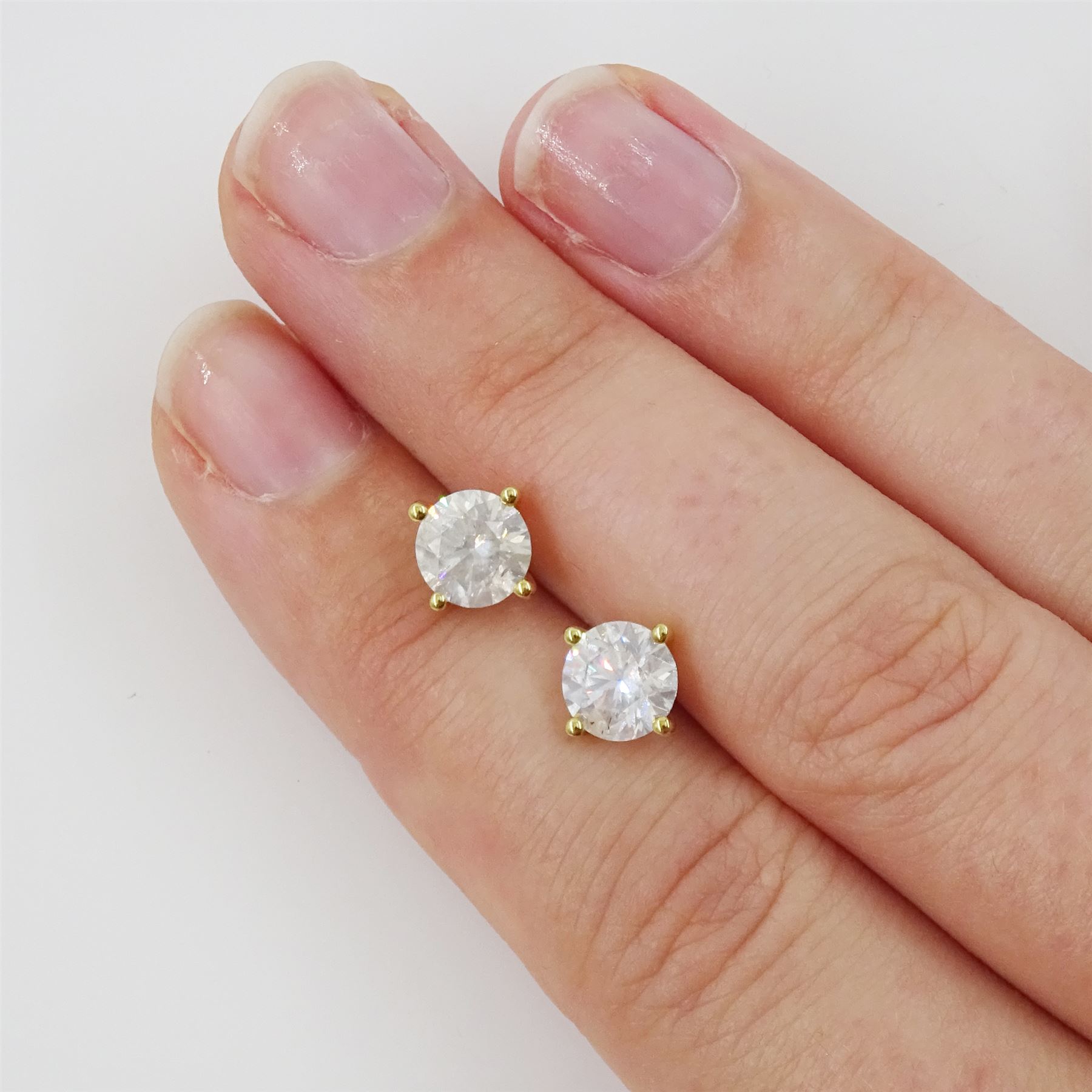 Pair of 18ct gold diamond earrings, each stud set with a single round brilliant cut diamond in a four claw setting, total diamond weight approx 2.15 carat