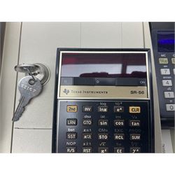 Four 1970s Sinclair electronic calculators - Cambridge in hard case with booklet; Scientific Programmable with Program Library and booklet; Scientific in hard case; and Oxford 300 in soft case with booklet; together with Texas PC-100 SR56 programmable slide-rule calculator on base station with readout, two booklets, keys and cover, serial no.9103093