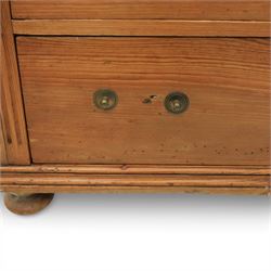 Late Victorian pine chest of drawers, the moulded top above four long drawers with brass drop handles and flower head escutcheons, flanked by pilasters, upon four turned compressed bun feet, 89cm x 103cm x 54cm