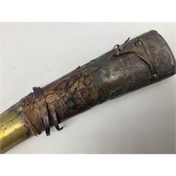 Late 19th/20th century Middle Eastern jambiya dagger the 36cm broad curved double edged steel blade with traces of script, horn and copper backed waisted white metal hilt with three roundel buttons; in ornate white metal and leather mounted brass and steel scabbard L60.5cm overall