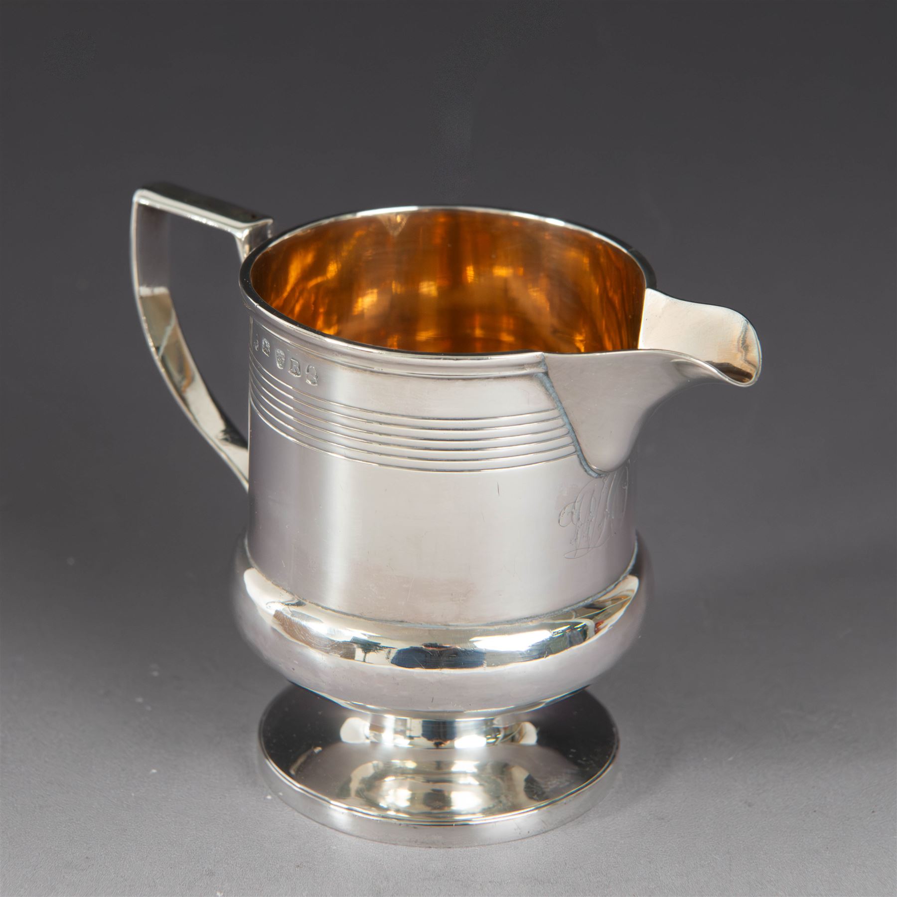 George III silver cream jug, of bellied form with ribbed decoration and angular handle, hallmarked London 1812, maker's mark worn and indistinct