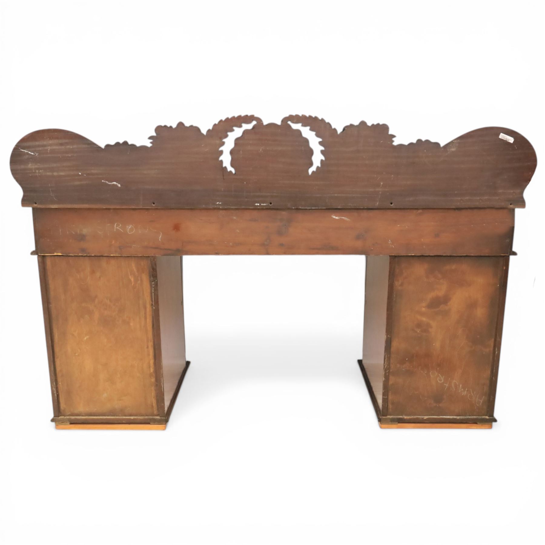Mid Victorian mahogany pedestal sideboard, the rectangular top with raised back centred by a carved shell within scrolling acanthus and foliate cresting, over a central shaped frieze drawer flanked by two short drawers, above a kneehole recess, flanked by panelled cupboard doors with carved corbel supports, enclosing shelved interiors