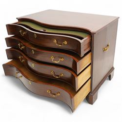 George III mahogany serpentine chest, moulded top over four cock-beaded drawers, the top drawer fitted with baize lined slide opening to reveal divisions,  enclosed by canted and fluted upright corners, the drawer fronts fitted with brass swan neck handles and circular plates with oval escutcheons, lower moulded edge over bracket feet, on lignum vitae castors