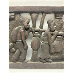 Carved African wall plaque, depicting a village, signed P.Ngoy, H34cm, L114cm