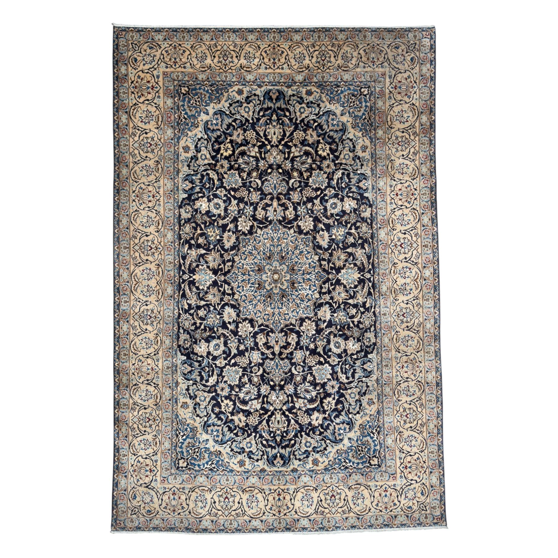 Central Persian Nain carpet, the deep blue field with finely drawn scrolling palmettes and flowering vines around a central ivory and sky blue rosette medallion, enclosed by an ivory border of interlaced floral arabesques and lotus forms between multiple guard stripes, from the region of Nain