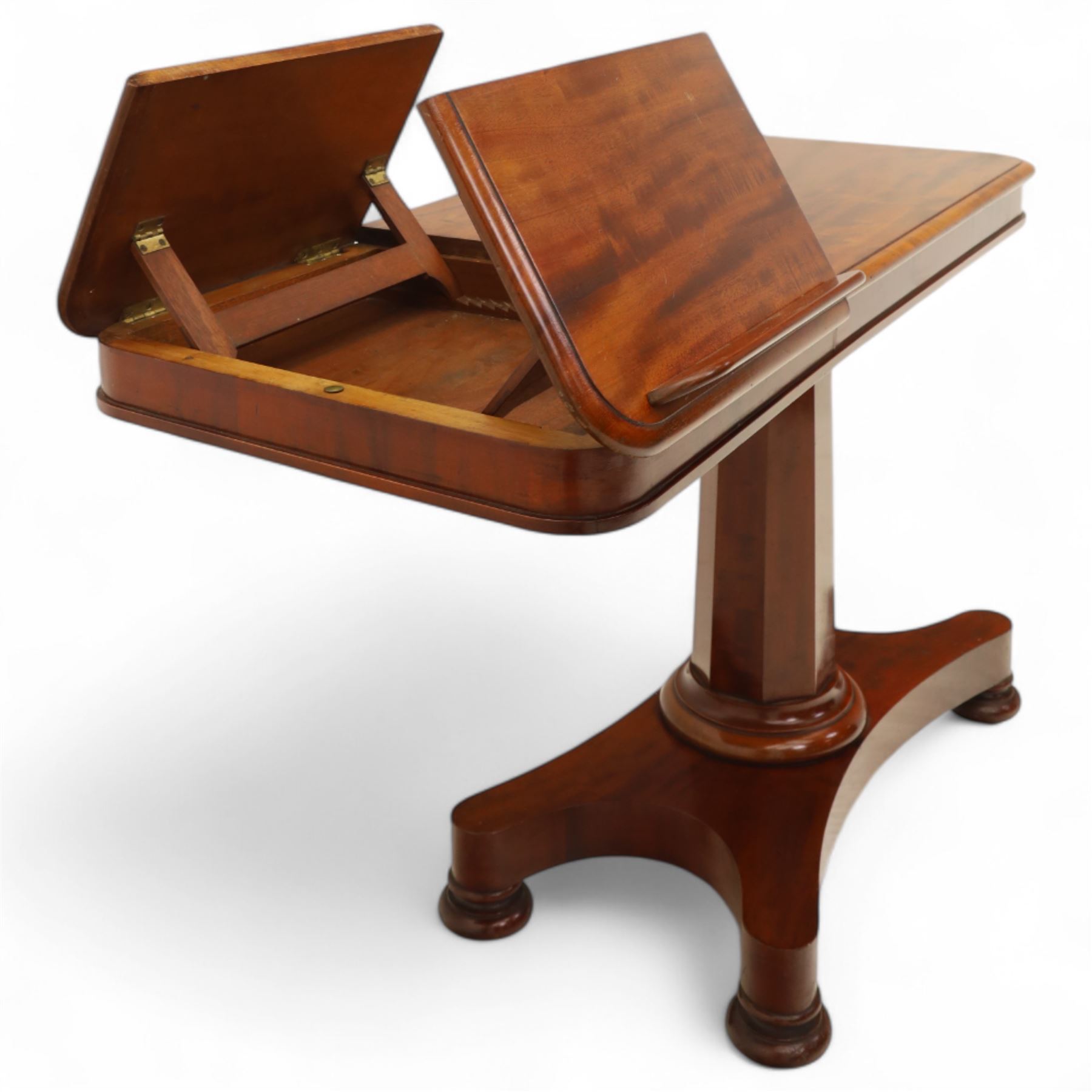 William IV mahogany reading table, the rectangular top with rounded corners and moulded edge, one end fitted with two hinged adjustable reading slops with two rests, the sliding top with a sprung stay mechanism, supported on a single tapered faceted column  with turned collar on a quatreform base with compressed bun feet