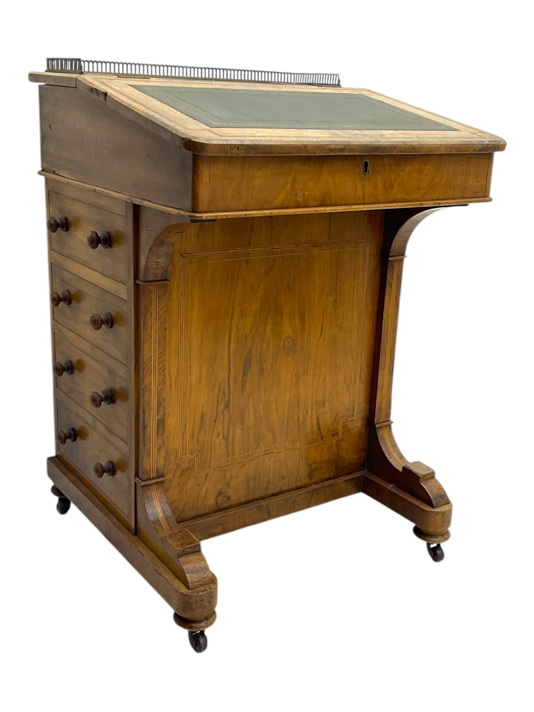 Early 19th century burr walnut Davenport desk, sloped leather-inset writing surface with brass gallery, fitted with an inkwell compartment and pen slot, four drawers to one side, raised on scrolled supports terminating in castors