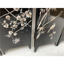  Late 19th / early 20th century Japanese lacquered table top cabinet, heavily decorated with mother of pearl inlay depicting blossoming branches, flowers and birds, the two hinged doors between longer drawers opening to reveal interior fitted with four short drawers, with lift up hinged canted lid, H28cm D9.5cm W23cm, together with mother of pearl inlaid miniature folding screen, dish decorated with walking figures with crimped edge, boxes decorated with flowers, birds and gilt etc