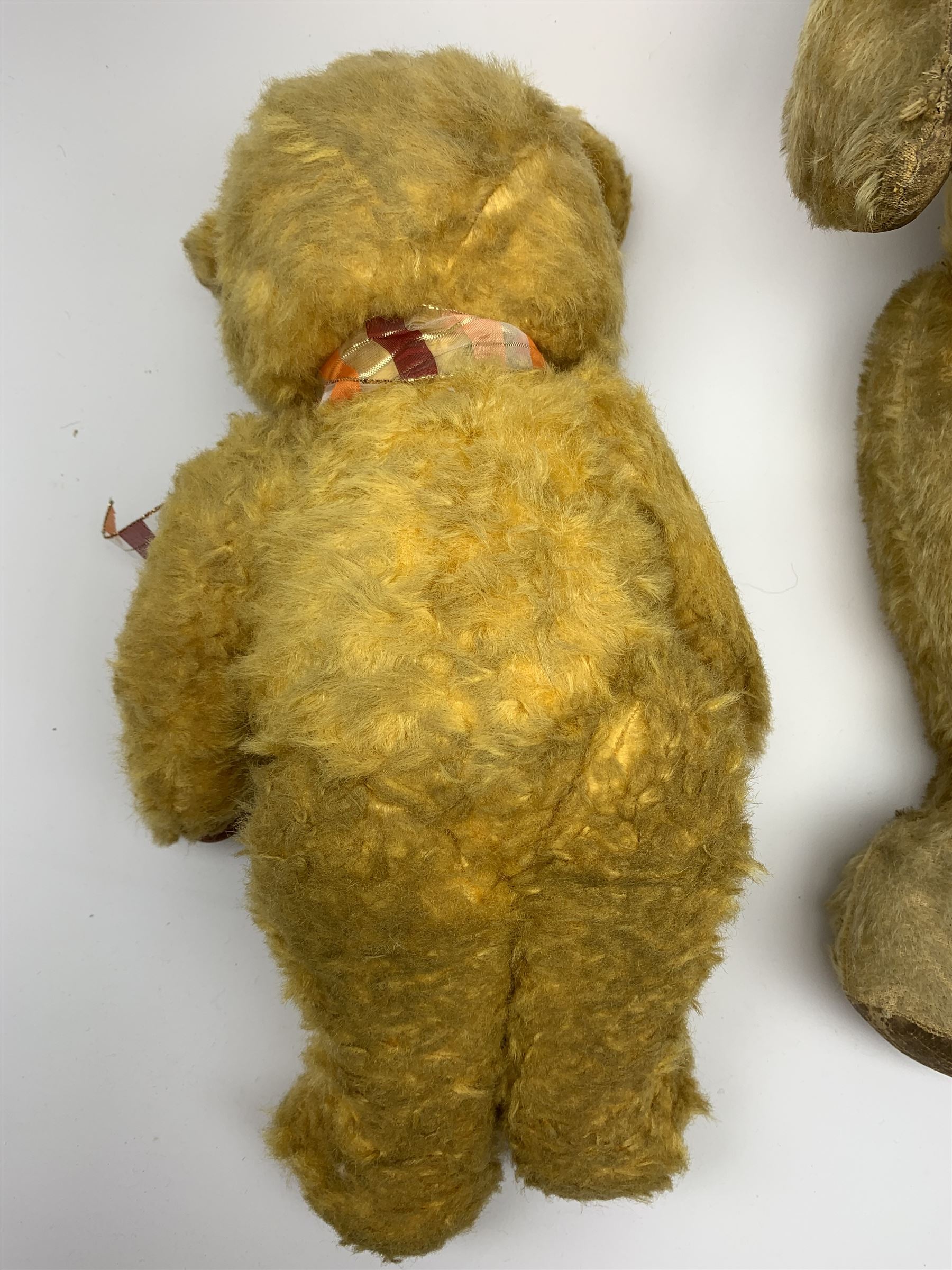 1950s English large wood wool filled teddy bear with swivel jointed head, glass type eyes and vertically stitched nose and mouth and jointed limbs with rexine paw pads H33