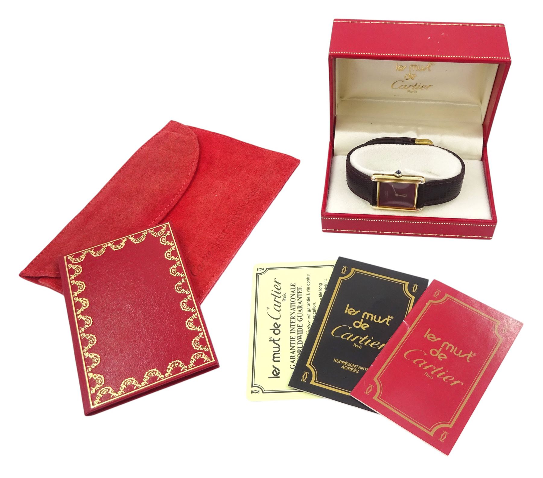 Must de Cartier silver-gilt manual wind wristwatch, burgundy dial, back case No 6 141961, hallmarked, on Cartier burgundy leather strap, with gilt buckle boxed with certificate of origin dated 1981