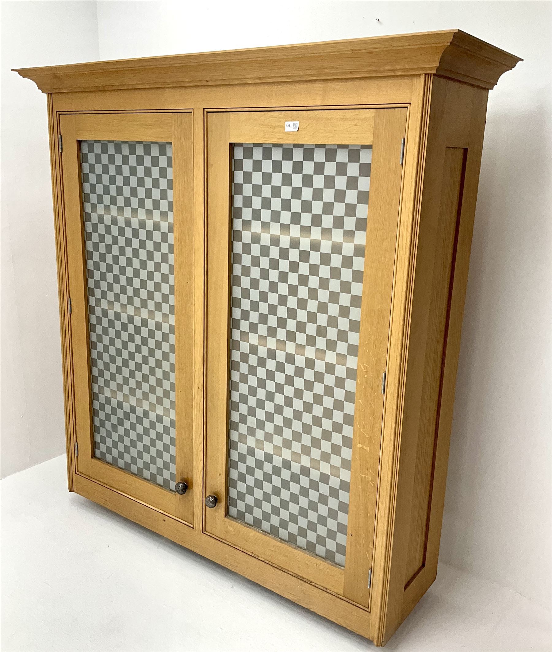 Smallbone light oak bookcase, projecting cornice above two chequered opaque glazed doors enclosing three adjustable shelves