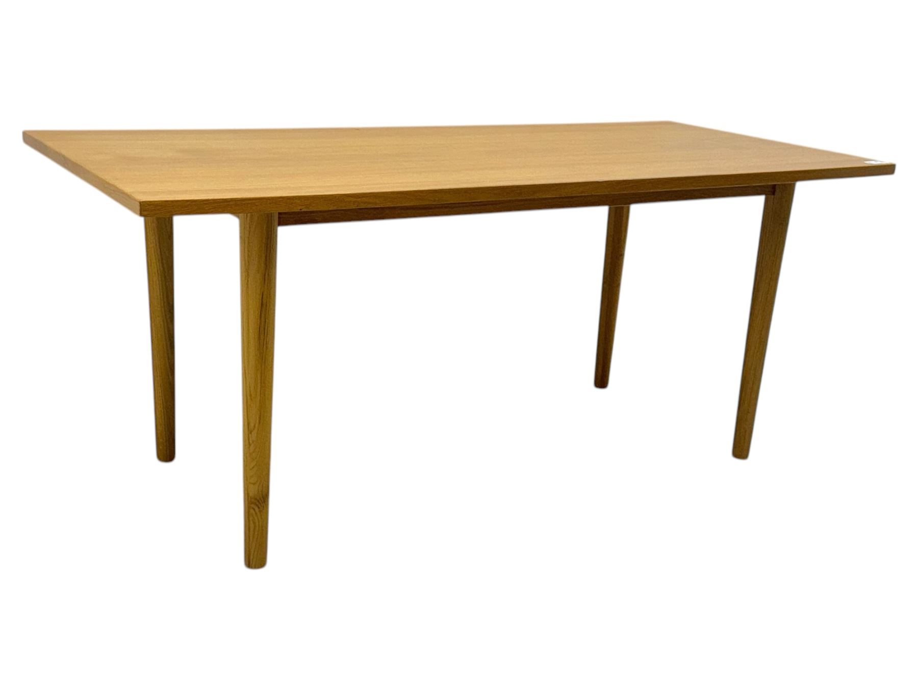 Ikea - Rectangular oak table, slim rectangular top over rounded edges, supported by tapered cylindrical legs  