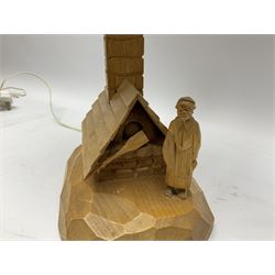 Mid 20th century Paul Caron carved table lamp, modelled as man standing before an oven, the chimney supporting the panelled shade, the base signed P.E. Caron, H42cm