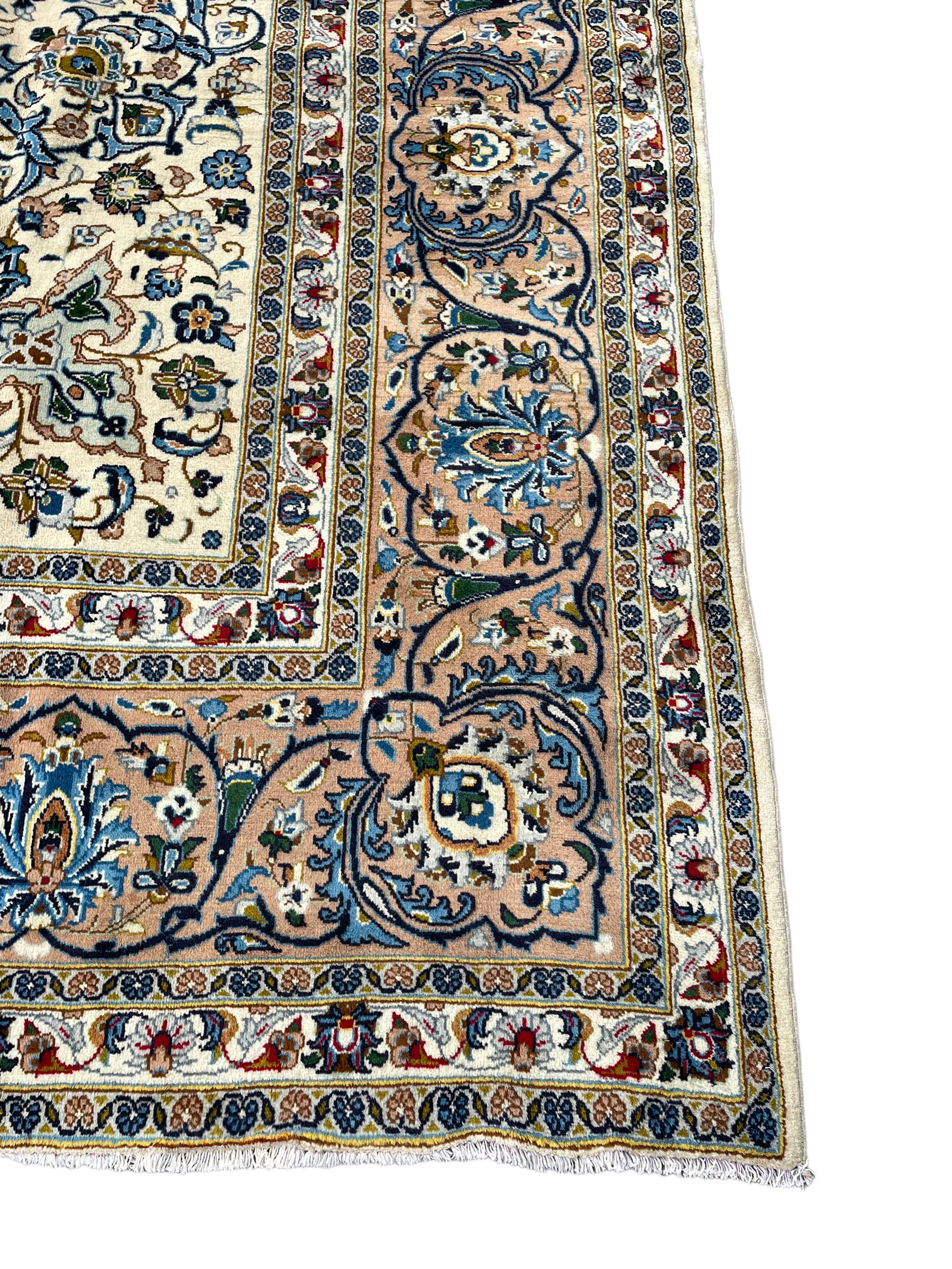 Persian Kashan ivory ground carpet, the interlaced foliate medallion surrounded by trailing plant motifs interlaced with scrolls, the guarded border with repeating stylised flower heads