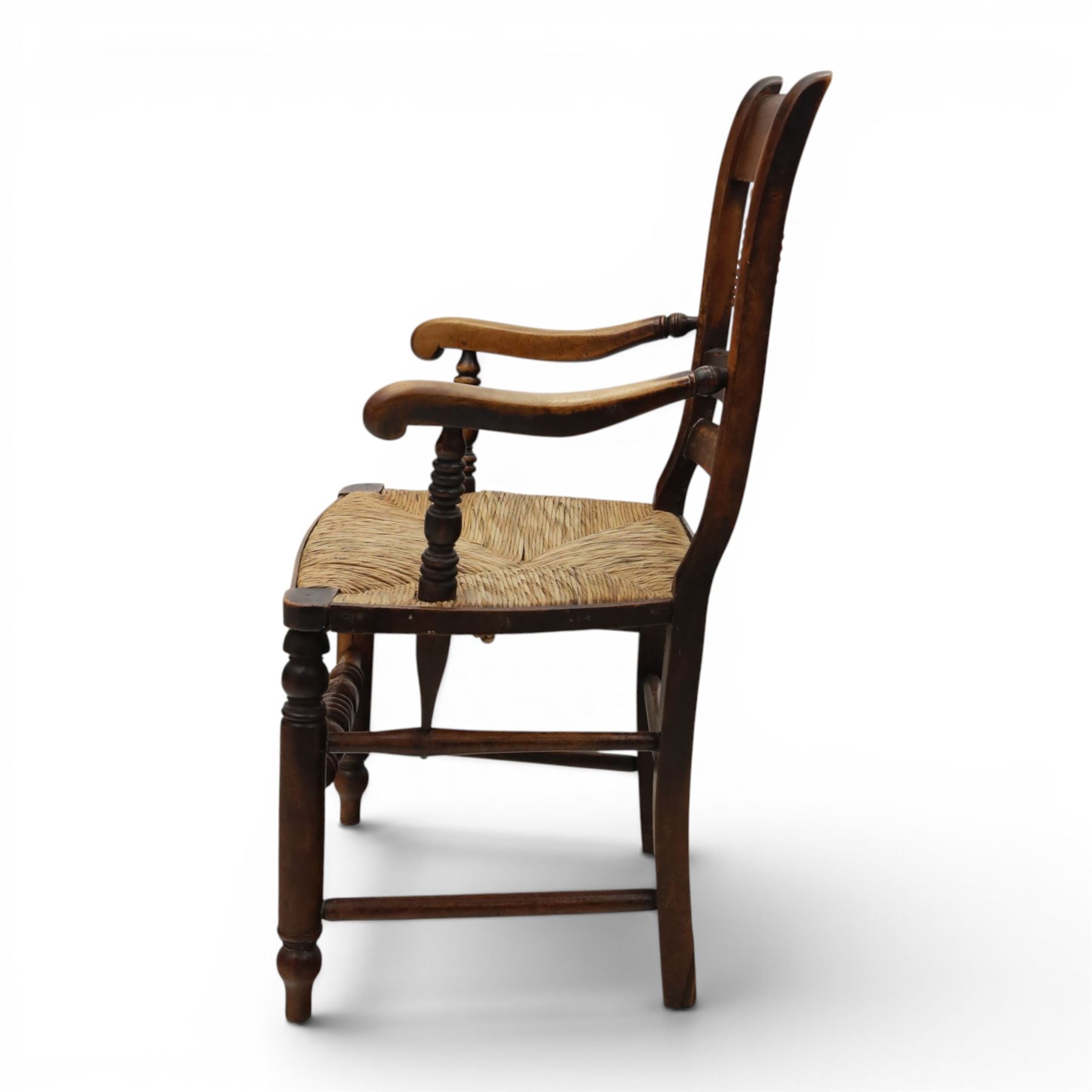 19th century elm chair, with curved top rail and bobbin turned spindles, woven rush seat, on turned legs united by front stretcher