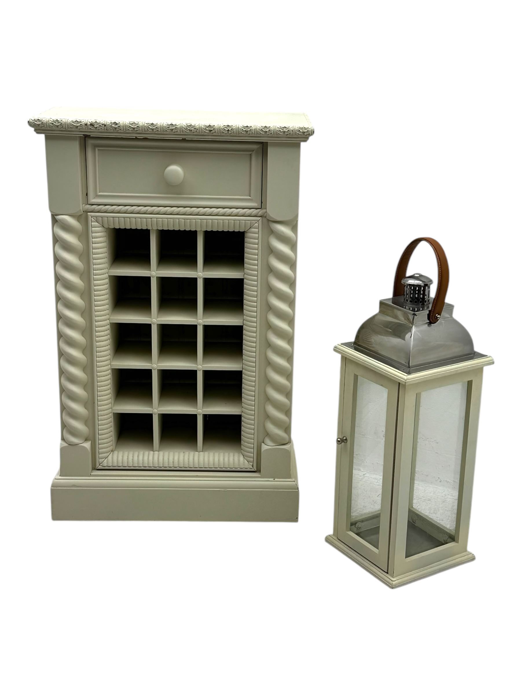 Contemporary painted wooden wine cabinet, rectangular form with carved leaf moulded cornice over single drawer and fifteen bottle compartments, flanked by spiral twist pilasters; together with a cream painted and chrome lantern, with glazed sides and leather handle (2)