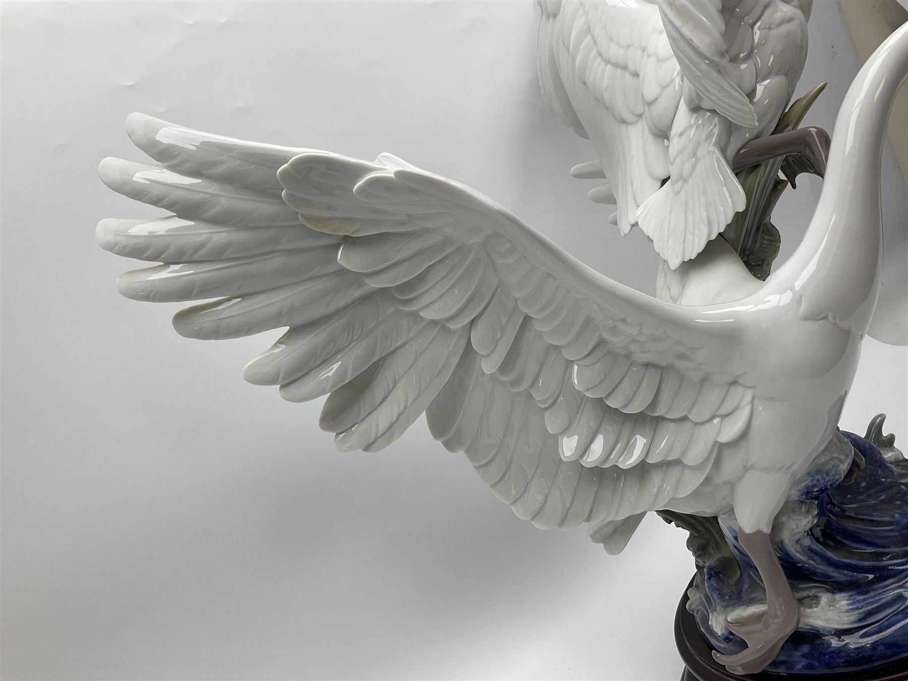 Large Lladro figure group, Swans Take Flight, modelled as two swans upon raised on circular wooden plinth, sculpted by Salvador Debon, H68cm