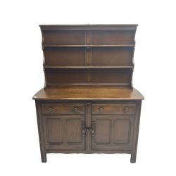 Ercol - dark elm dresser, raised two-tier plate rack above two drawers and two panelled cupboards