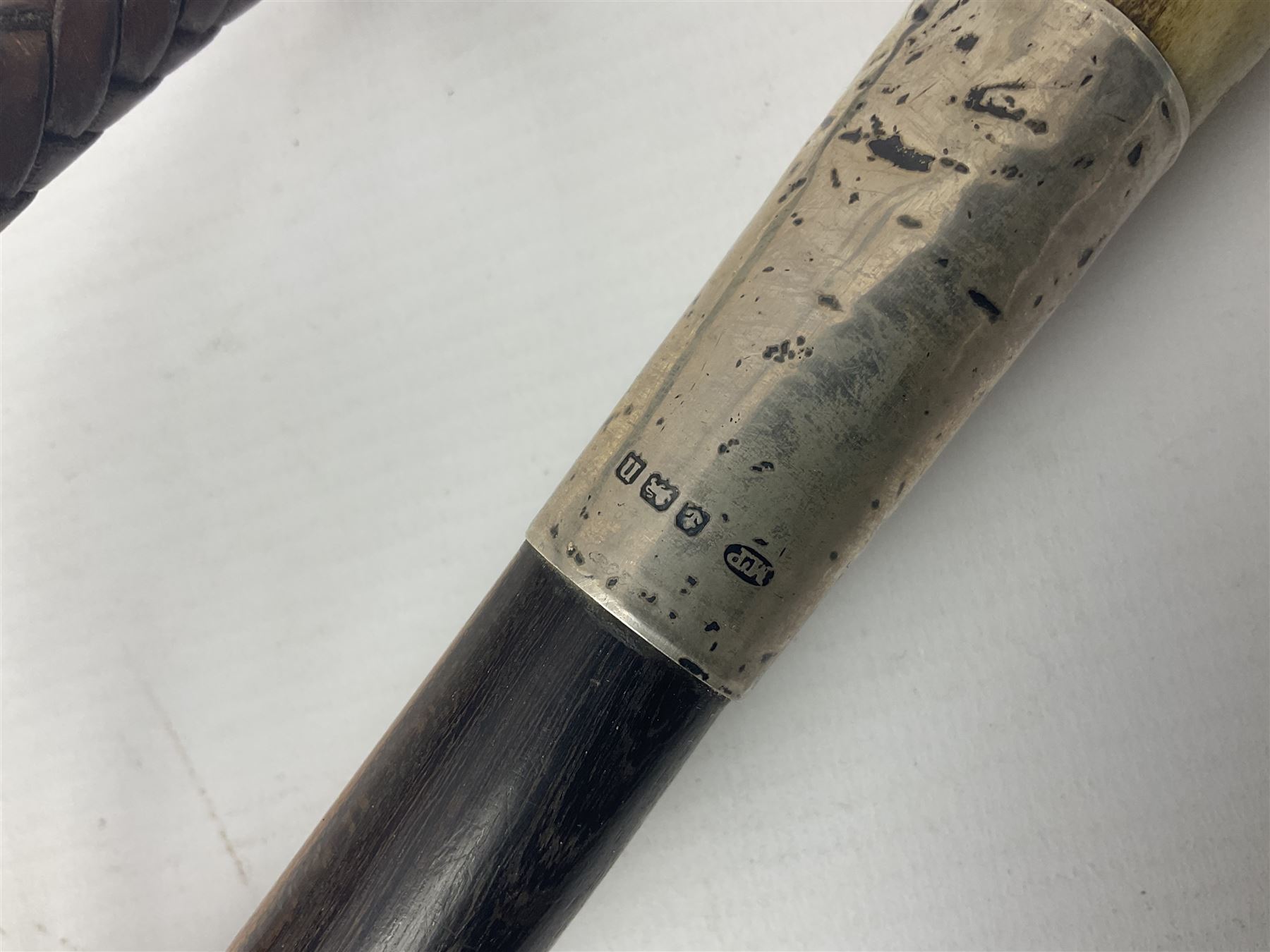 Collection of hunting crops and riding whips, including horn handle examples with silver cuffs