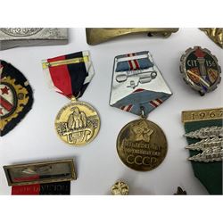 Collection of approximately sixty worldwide medals, metal badges, belt buckles, cloth badges, trench art, brass button stick etc