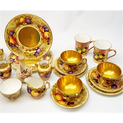 A selection of Aynsley fruit decorated teawares, comprising three large teacups and saucers, three smaller teacups and saucers, five side plates, two larger plates, an open sucrier, milk jug, and two vases, signed D Jones and N Brunt, together with five Baron China mugs with similar fruit decoration, and a small Worcester Locke & Co vase decorated with a robin perched upon a blossoming branch (a/f), all items with marks beneath. 