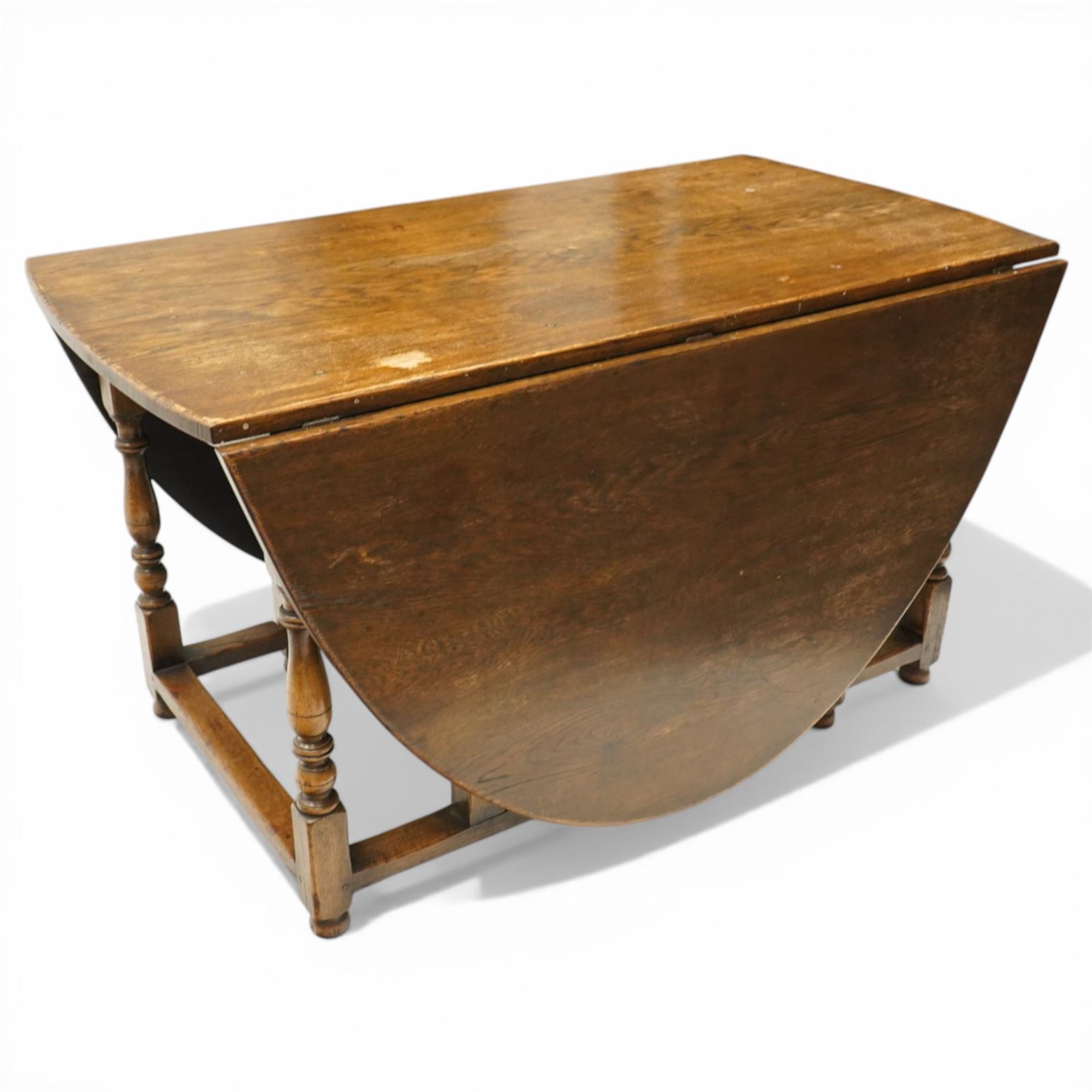 George III oak drop-leaf oval dining table with harlequin set of seven 18th century and later chairs including a comb-back Windsor, the table with turned gatelegs united by box stretcher, shaped apron extending to 212cm, the chairs of various forms, three Windsor carvers, a comb-back Windsor, plus a set of three Georgian mahogany dining chairs, pierced splat backs, with matching drop-in upholstered seats