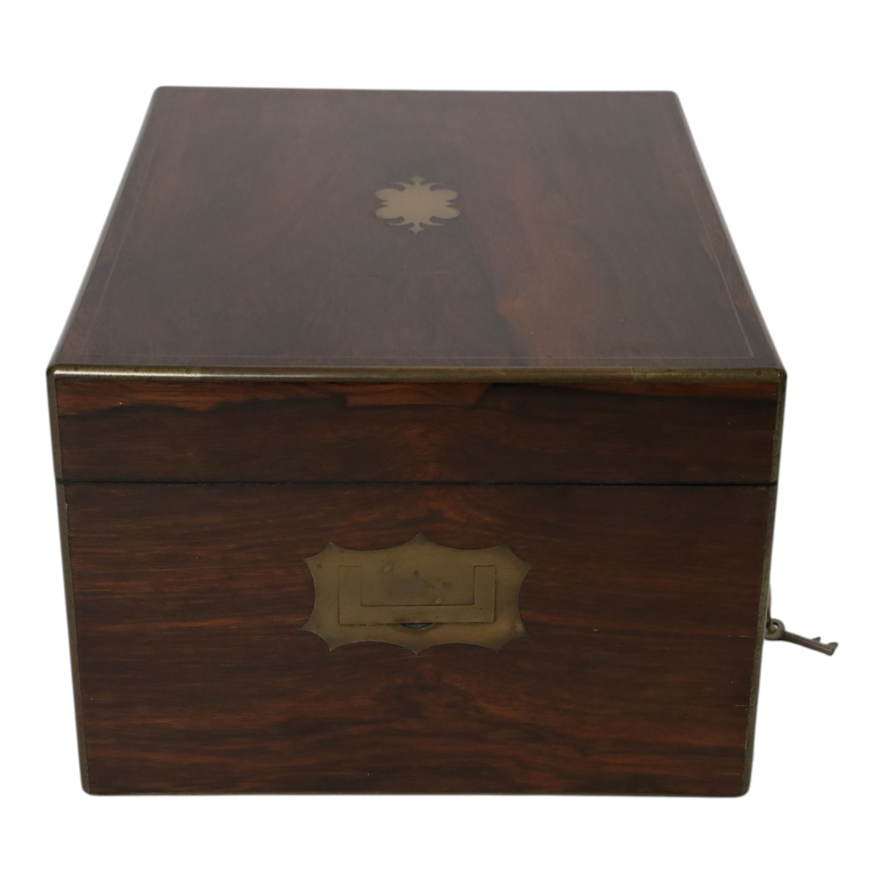  Victorian brass inlaid rosewood dressing table box, retailed by F.L. Hausburg, Liverpool, the lid centred by a brass cartouche, opening to reveal letter store to lid underside, above a fitted interior, with ten mounted cut glass jars, bottles and manicure set, within lift out leather trays, above jewellery drawer, with key, H17cm D24cm