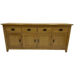 Light oak sideboard, fitted with four drawers and four panelled cupboards