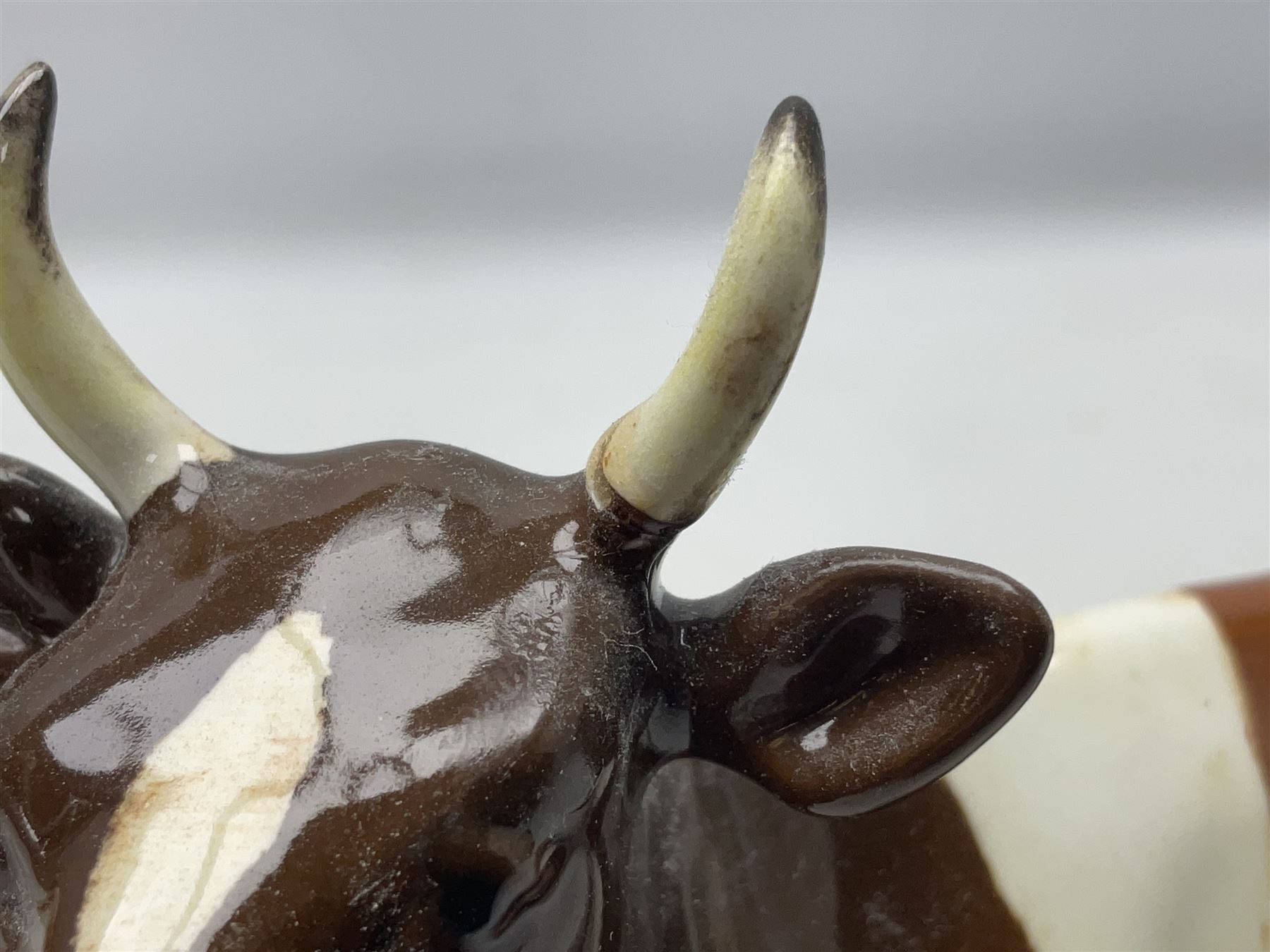 Five Beswick figures of cattle Comprising Ayrshire Bull Ch Whitehill Mandate, no 1454B, three Ayrshire Cow Ch Ickham Bessie, no 1350 and Ayrshire Calf, no 1249B, all with printed marks beneath