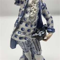 Meissen blue and white figure of a gentleman, modelled stood holding his black at full of flowers in one hand, and raising a flower above his head in the other, raised upon Greek key design base, with blue crossed swords and impressed C 73 and 149 marks beneath, H18cm