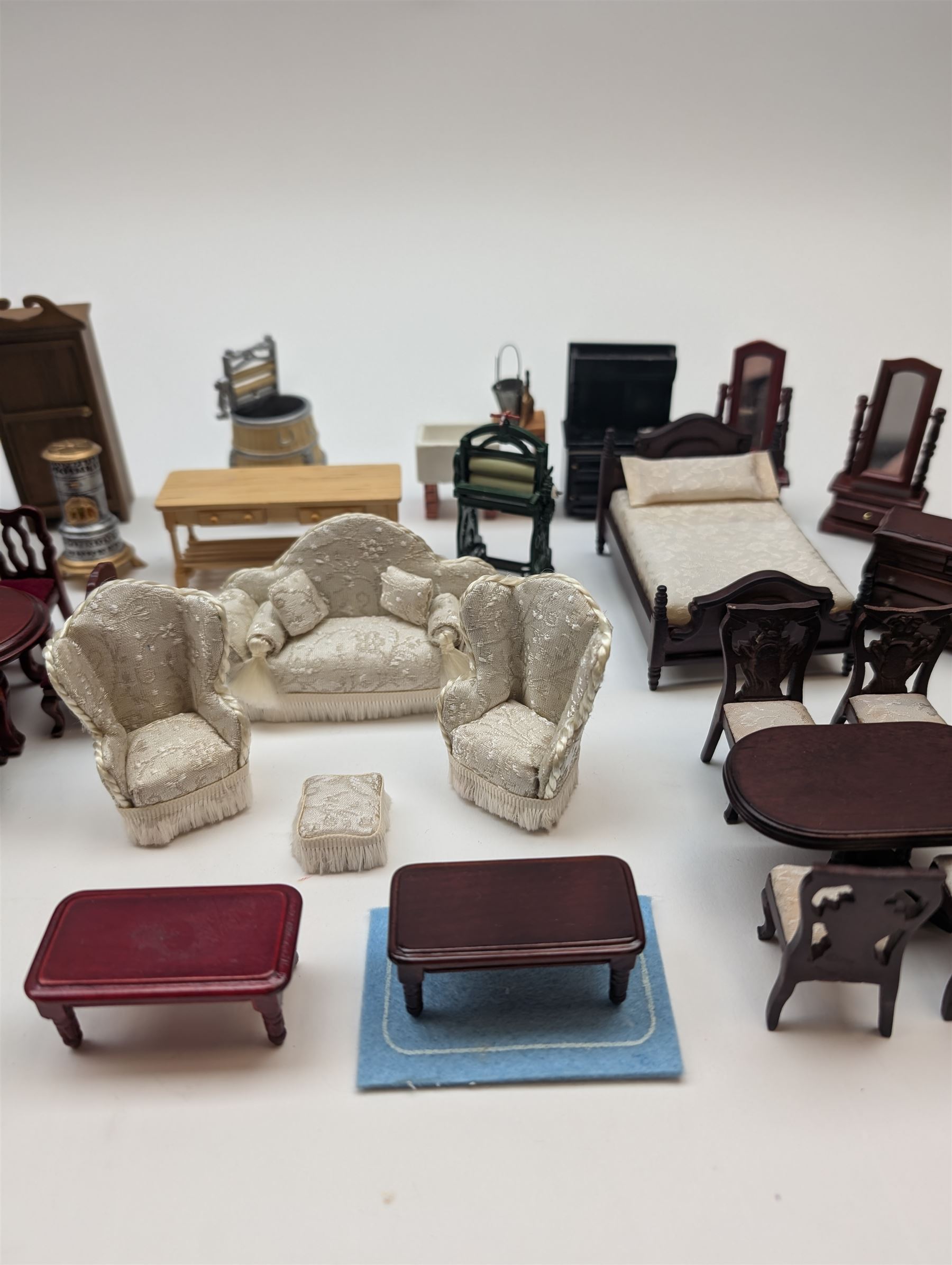 1:24 scale dolls house furniture, comprising stove, mangle, couch and arm chairs, bed, bathroom suite, two dining tables with chairs, side tables, cabinets, dressers, etc 