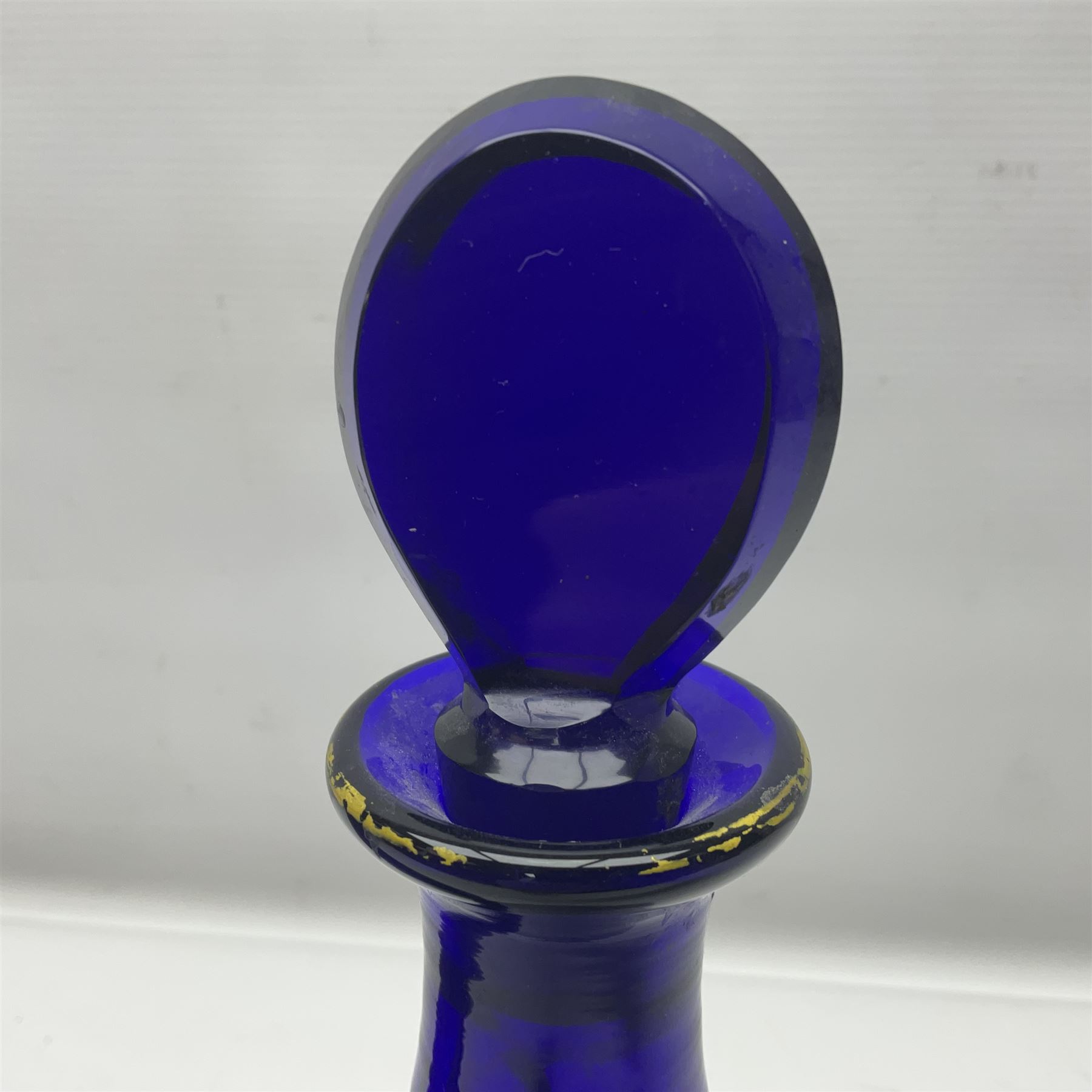 Pair of early 19th century blue glass decanters with teardrop stoppers, with gilt writing, the first marked Gin the second Brandy 