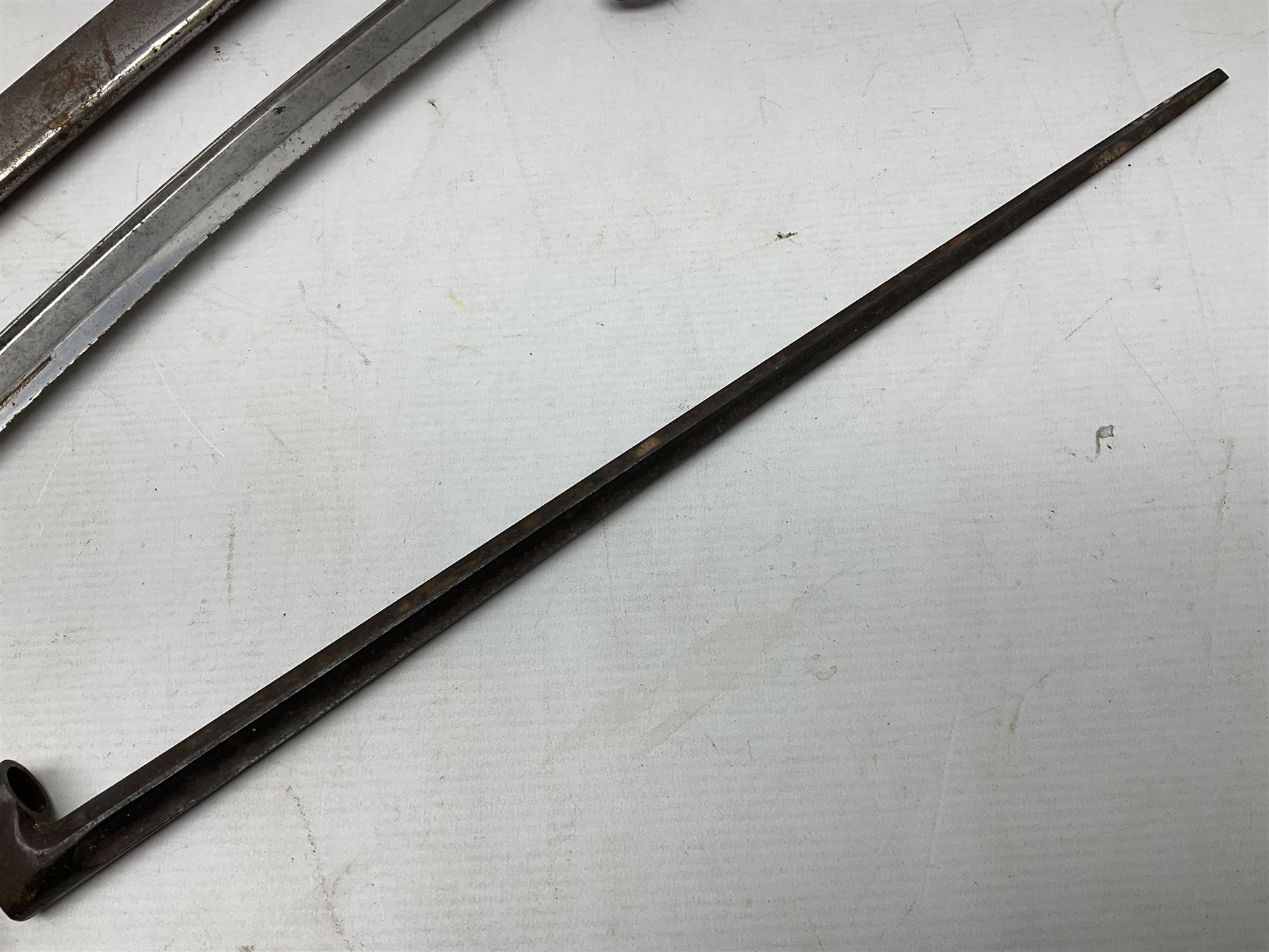 French model 1866 sabre bayonet, the 57.5cm curving blade marked St. Etienne 1873; in associated steel scabbard L71cm; and Mosin-Nagant M1891 socket bayonet with 43cm cruciform blade No.37068 (no scabbard) (2)