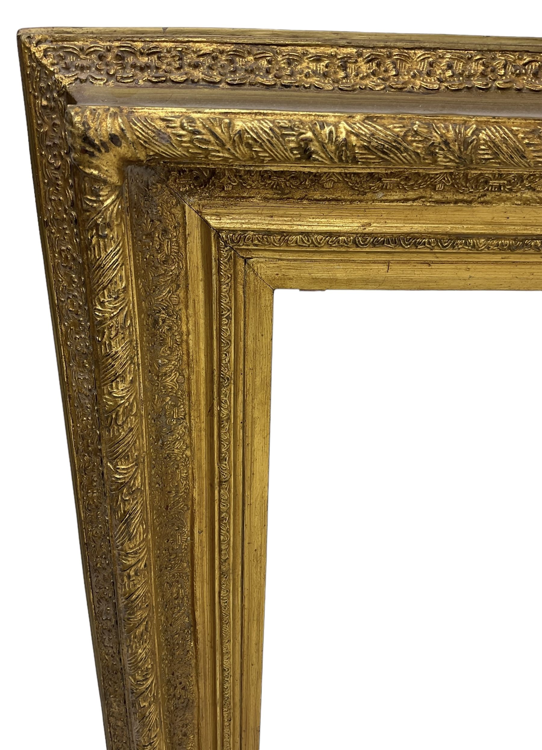 Victorian design gilt wall mirror, the frame decorated with moulded gold foliate patterns, with rectangular bevelled plate